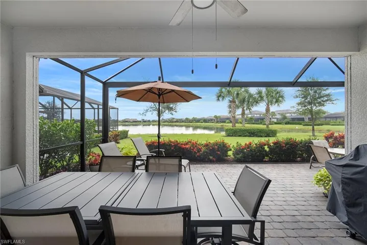 View of patio / terrace with a sunroom, a grill, and outdoor dining area