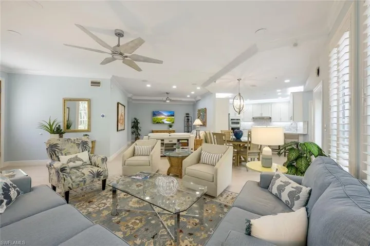 Living room featuring ornamental molding, plenty of natural light, wood finished floors, recessed lighting, and ceiling fan