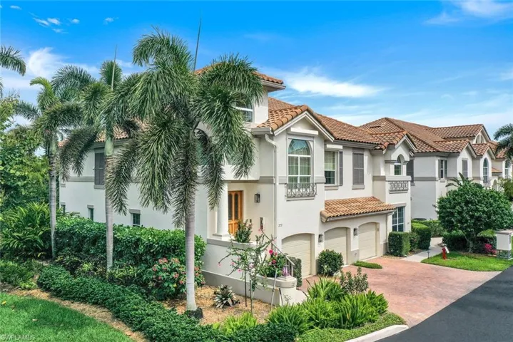 Mediterranean / spanish-style home with stucco siding, an attached garage, a tiled roof, and decorative driveway