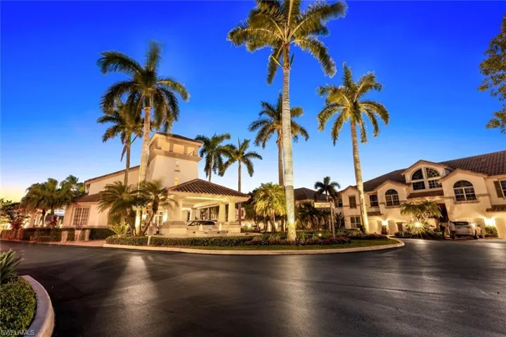 View of property at dusk