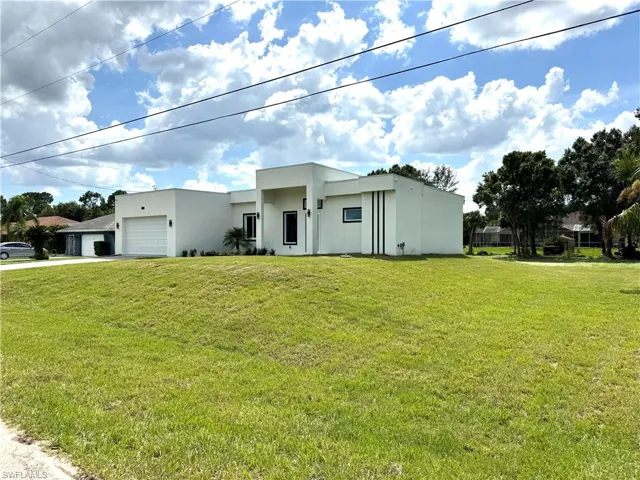 Modern white stucco exterior with a prominent recessed entry