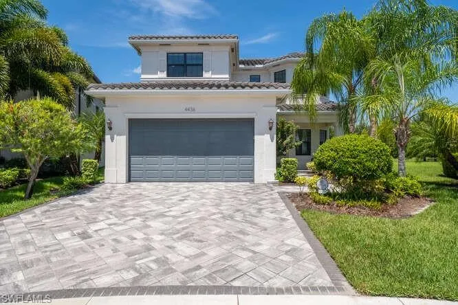 Mediterranean / spanish-style home with a garage