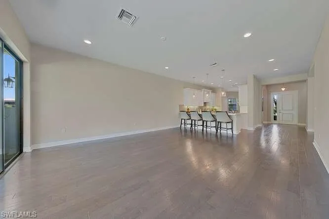 Unfurnished living room featuring wood flooring