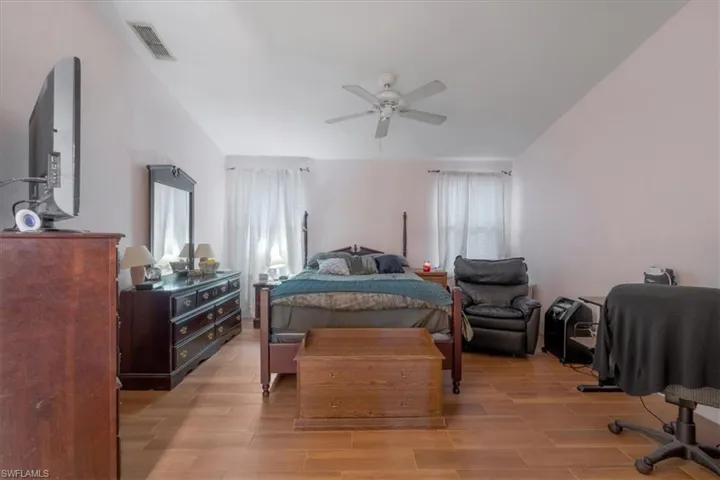 Bedroom with ceiling fan and light hardwood / wood-style flooring