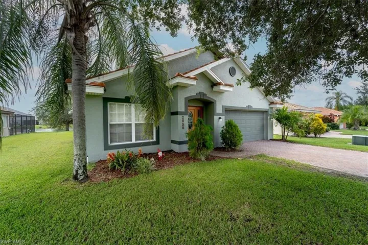 View of front of home with a garage and a front yard