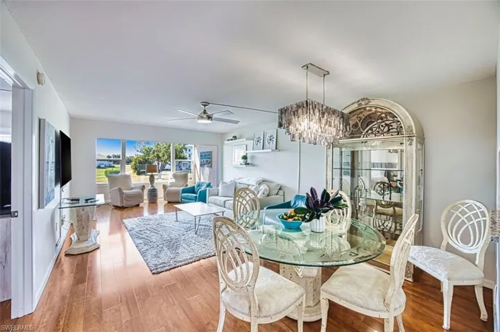 Dining space featuring a chandelier, hardwood / wood-style floors, and ceiling fan