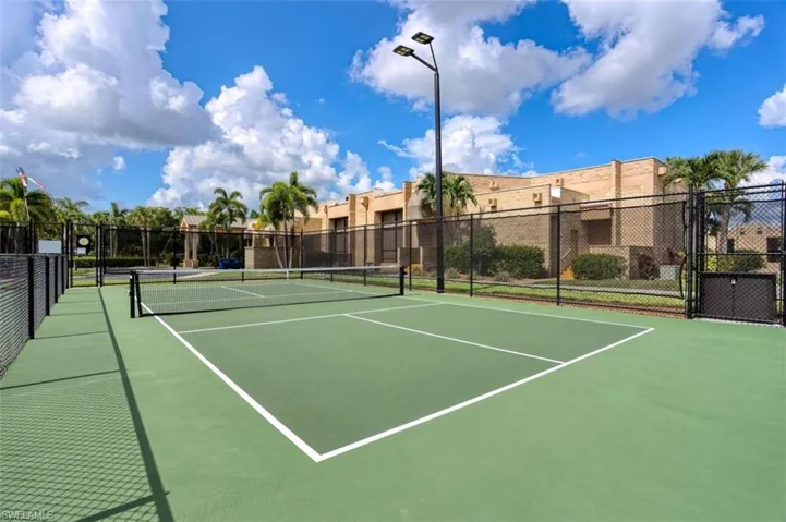 View of tennis court with community basketball court