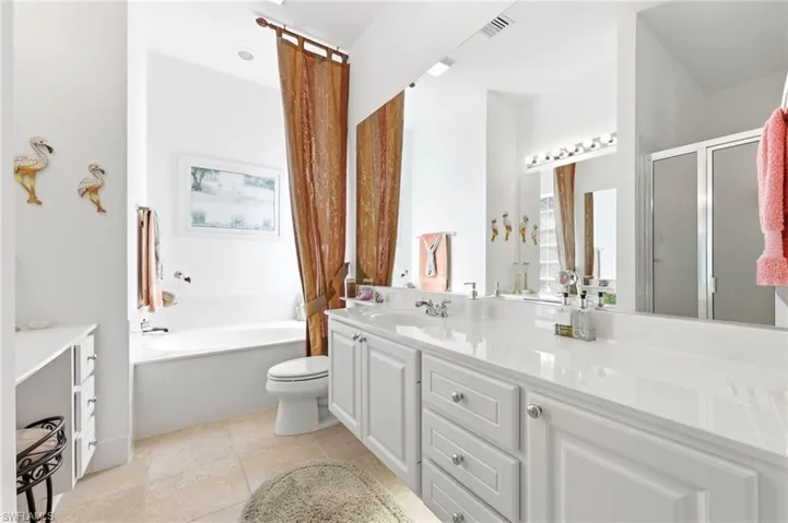 Master Bathroom with bathtub and floating cabinets