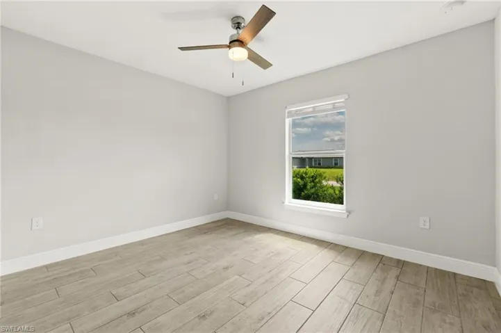 Spacious interior with neutral wall tones and wood-finish flooring
