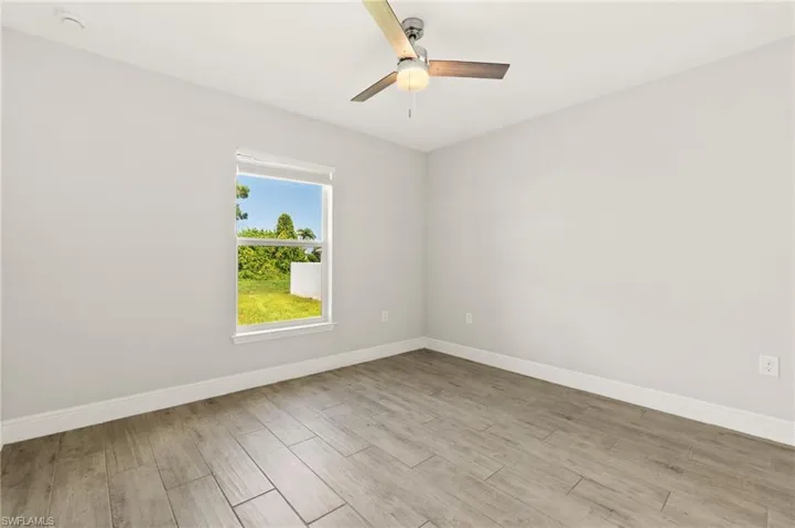 Bright room with light gray walls and wood-finish flooring