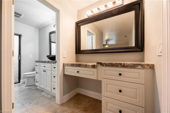Bathroom featuring vanity and toilet