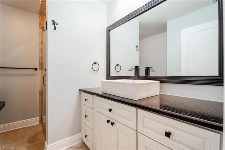 Bathroom with vanity and a shower with shower door