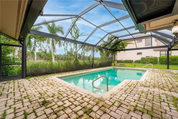 View of pool with a patio and a lanai