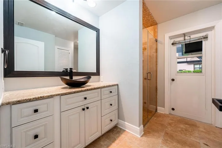 Bathroom featuring vanity and an enclosed shower