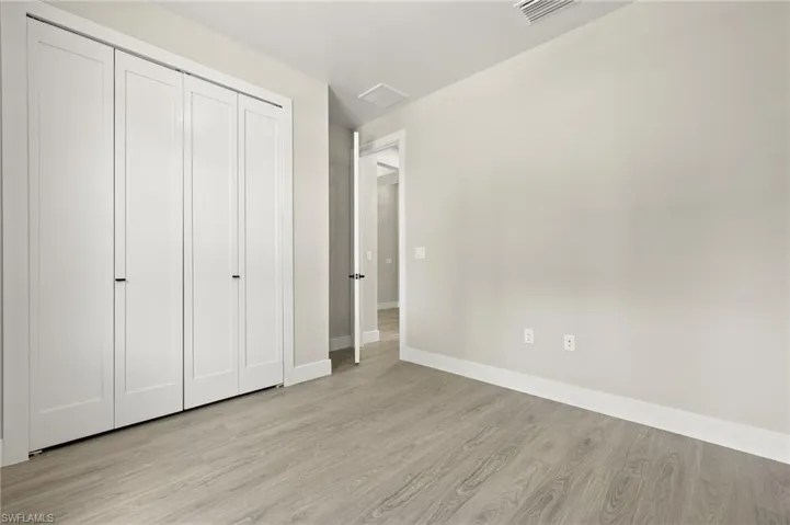 Unfurnished bedroom featuring a closet and light hardwood / wood-style flooring