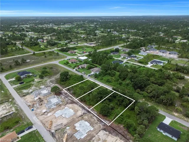Aerial view of property's location with nearby suburban area