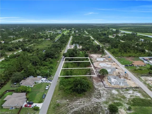 Aerial perspective of suburban area featuring property boundaries highlighted