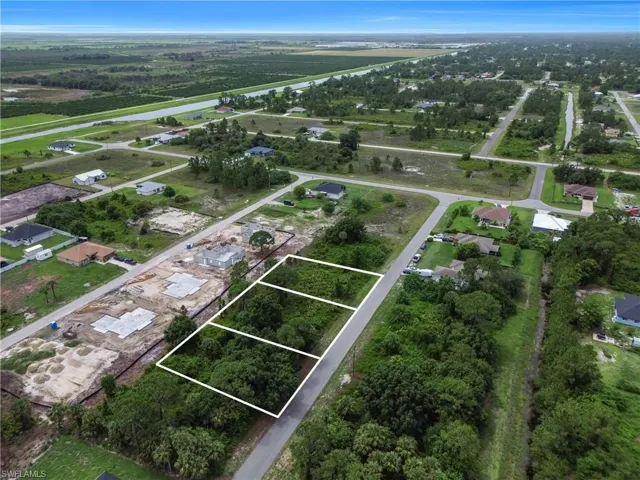 Aerial perspective of suburban area featuring property boundaries highlighted
