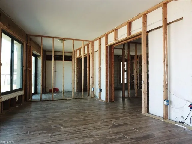 Miscellaneous room with dark wood-style flooring