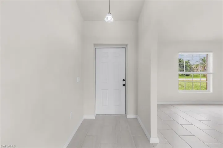 Entryway featuring light tile patterned floors