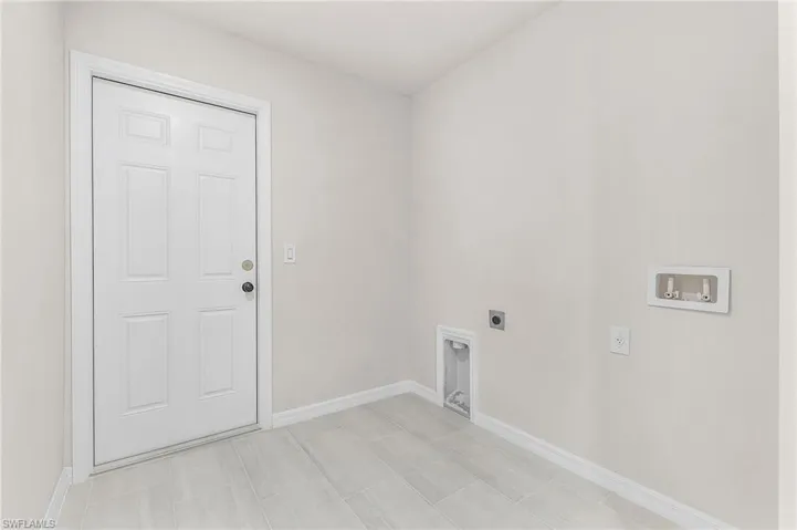 Clothes washing area featuring electric dryer hookup and washer hookup