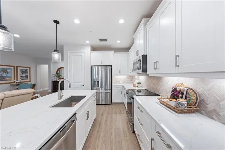 Kitchen with GE Profile stainless steel appliances. 42" Cabinets. Quarts Counters