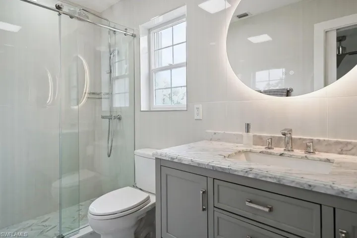 Bathroom with vanity and a shower stall