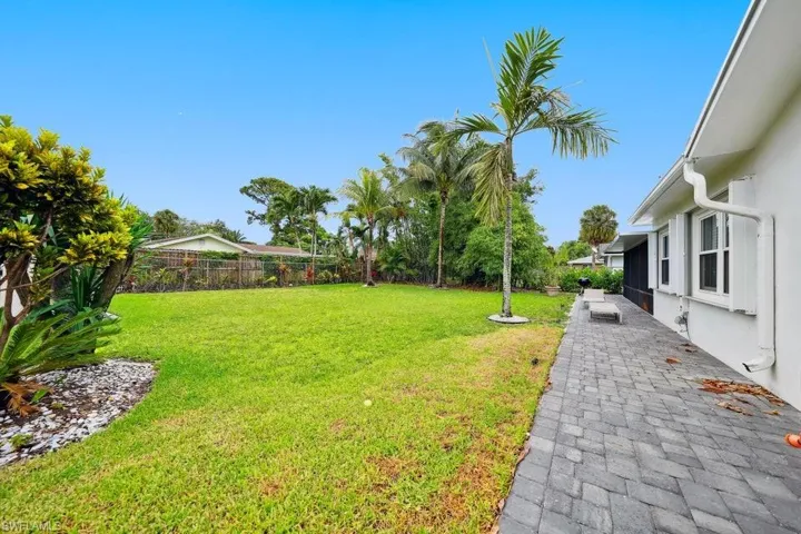 Fenced backyard with a patio