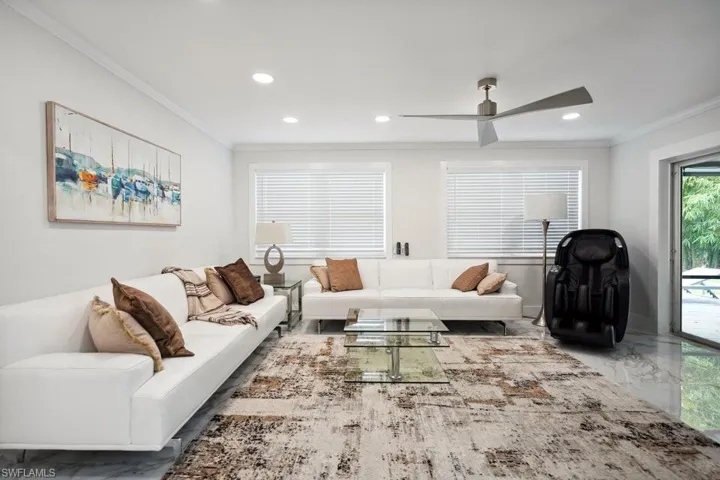 Living area featuring crown molding, marble tiled flooring, recessed lighting, and a ceiling fan