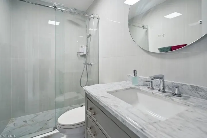 Full bathroom with a stall shower and vanity