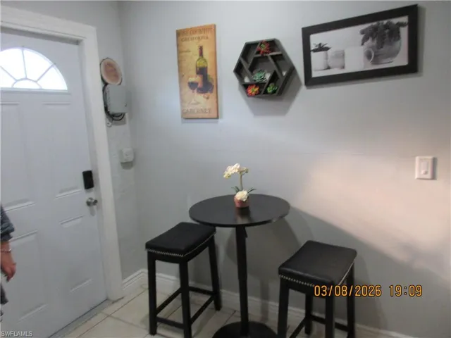 Entryway with baseboards and light tile patterned floors