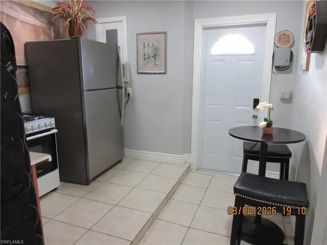 Kitchen with white gas range and light tile patterned floors