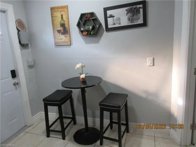 Dining space with baseboards and light tile patterned floors
