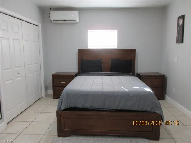 Bedroom with a closet and light tile patterned floors