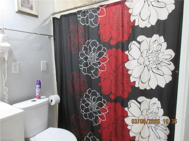 Full bath with a shower with shower curtain and vanity