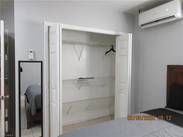 Bedroom with a mini split for heating / cooling and a closet