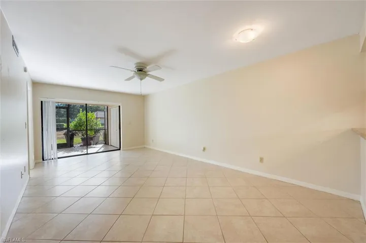 Unfurnished room featuring a ceiling fan and light tile patterned floors