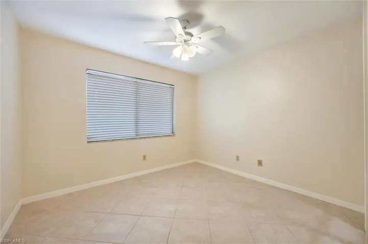 Unfurnished room featuring a ceiling fan and light tile patterned flooring