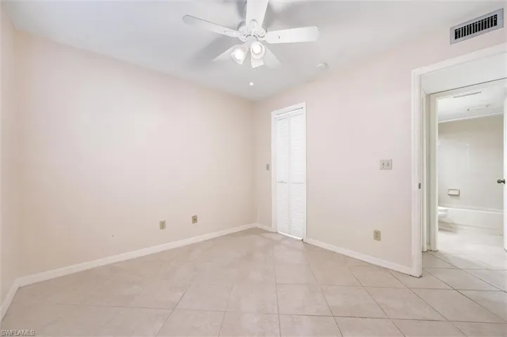 Unfurnished bedroom featuring light tile patterned floors, a ceiling fan, and a closet