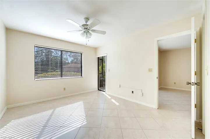 Unfurnished room with ceiling fan and light tile patterned floors