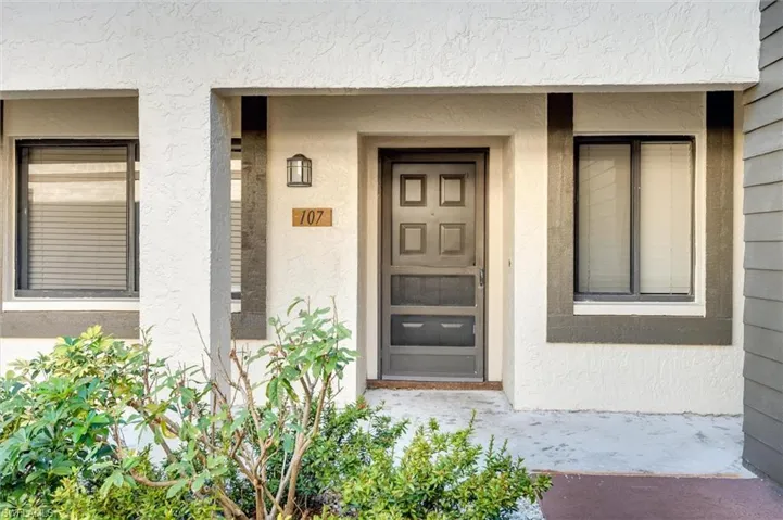 Property entrance featuring stucco siding