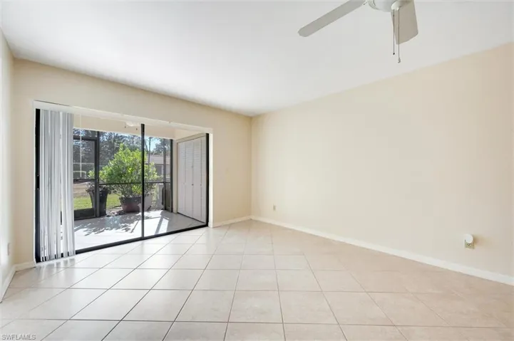 Empty room featuring light tile patterned floors and ceiling fan