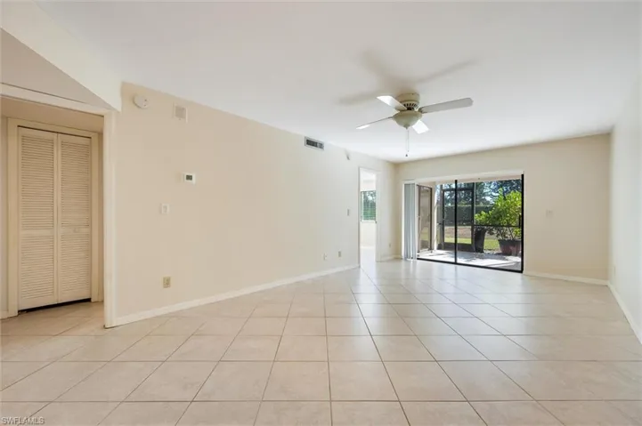 Unfurnished room with ceiling fan and light tile patterned flooring