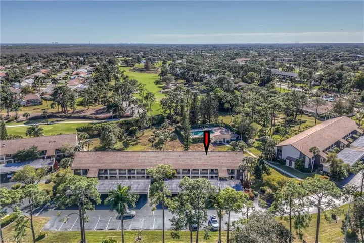 Aerial overview of property's location with a golf course and nearby suburban area