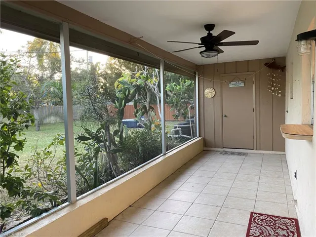 Unfurnished sunroom with ceiling fan