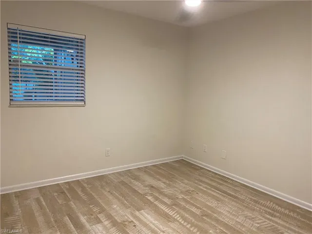 Empty room featuring baseboards