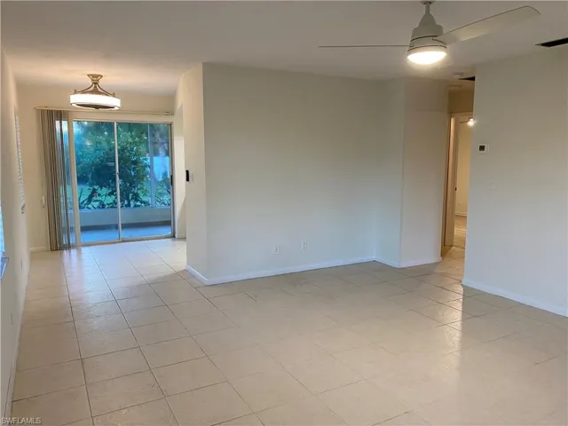 Unfurnished room featuring a ceiling fan and light tile patterned floors