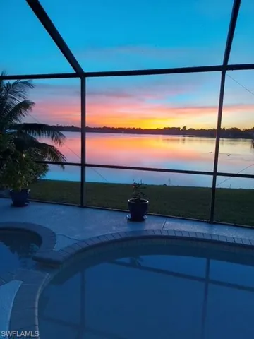 Pool at dusk with a water view