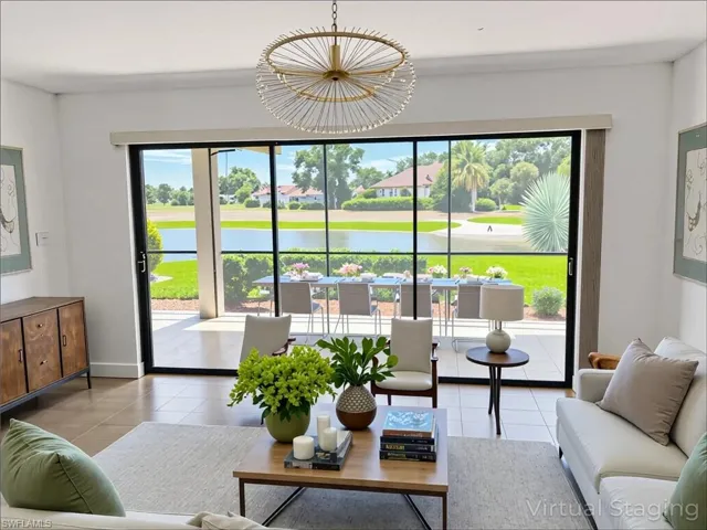 Living area with tile patterned floors, plenty of natural light, and a water view