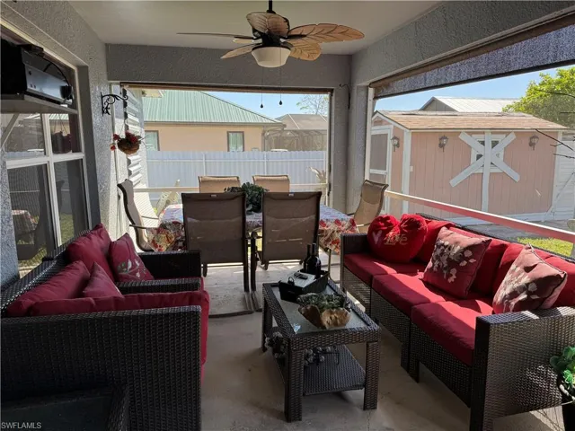Sunroom / solarium with a ceiling fan, outdoor dining space, and outdoor lounge area